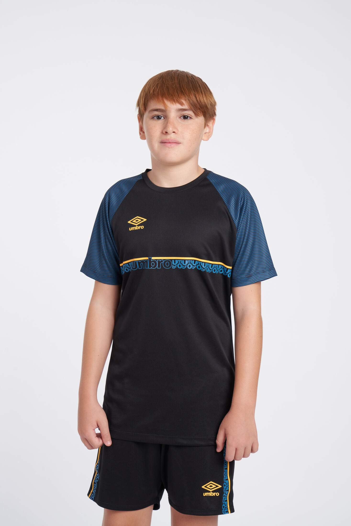 CAMISETA UMBRO SPIRITO JERSEY - JNRBLACK / ORANGE POP / PETROL BLUE 